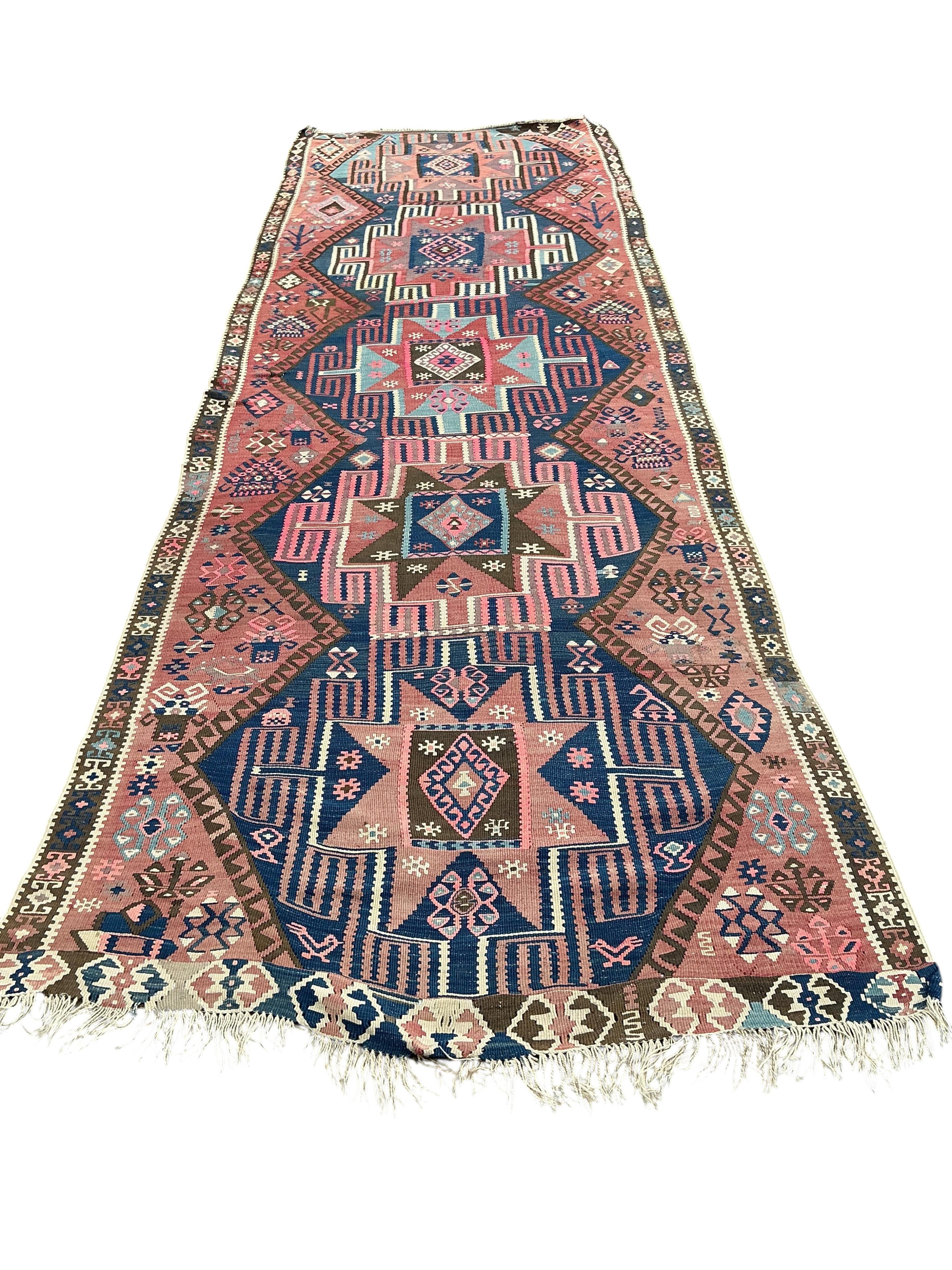 An early 20th century Turkish red ground flat weave Kilim runner, 430 x 138cm